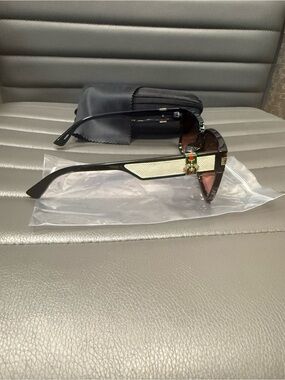 Black Sunglasses with Beige Accent and Green-Red Detail
